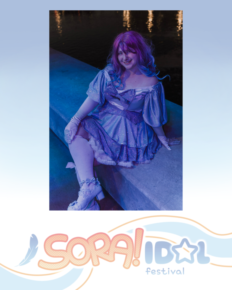 Person in a sparkly purple dress and gloves sitting by water at night under blue and purple lighting